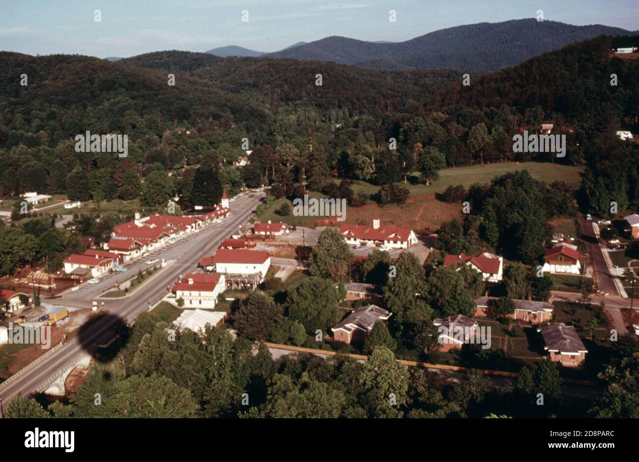 Aerial view of Helen; Georgia; near Robertstown. Main Street shops along Georgia highway 17/75 are at the left. Lower income government housing units are at the lower right. City hall is seen in the center of the photo in front of Unicoi Hill; part of a Unicoi Recreation State Park. The town has experienced a surge of tourism and commercial growth by using a bavarian alpine theme in the business district. The photographer took the picture from a balloon whose shadow is seen at the lower left Stock Photo