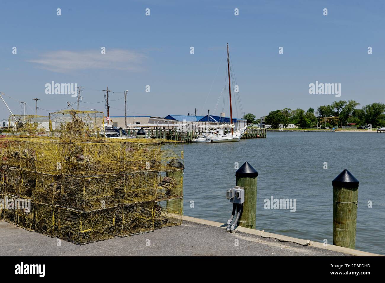 Crab pots stacked on a marina dock before loading onto a fishing boat