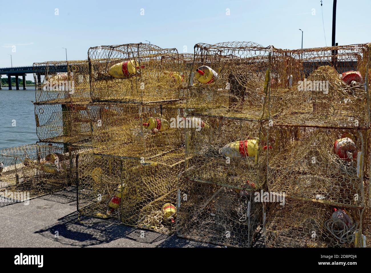 Crab pots stacked on a marina dock before loading onto a fishing boat