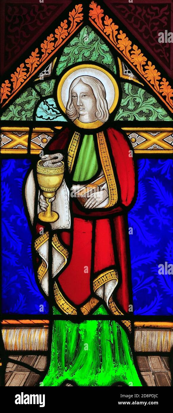 St. John, holding Chalice with Snake, stained glass window, by Joseph Grant of Costessey, 1857, Wighton, Norfolk, England Stock Photo