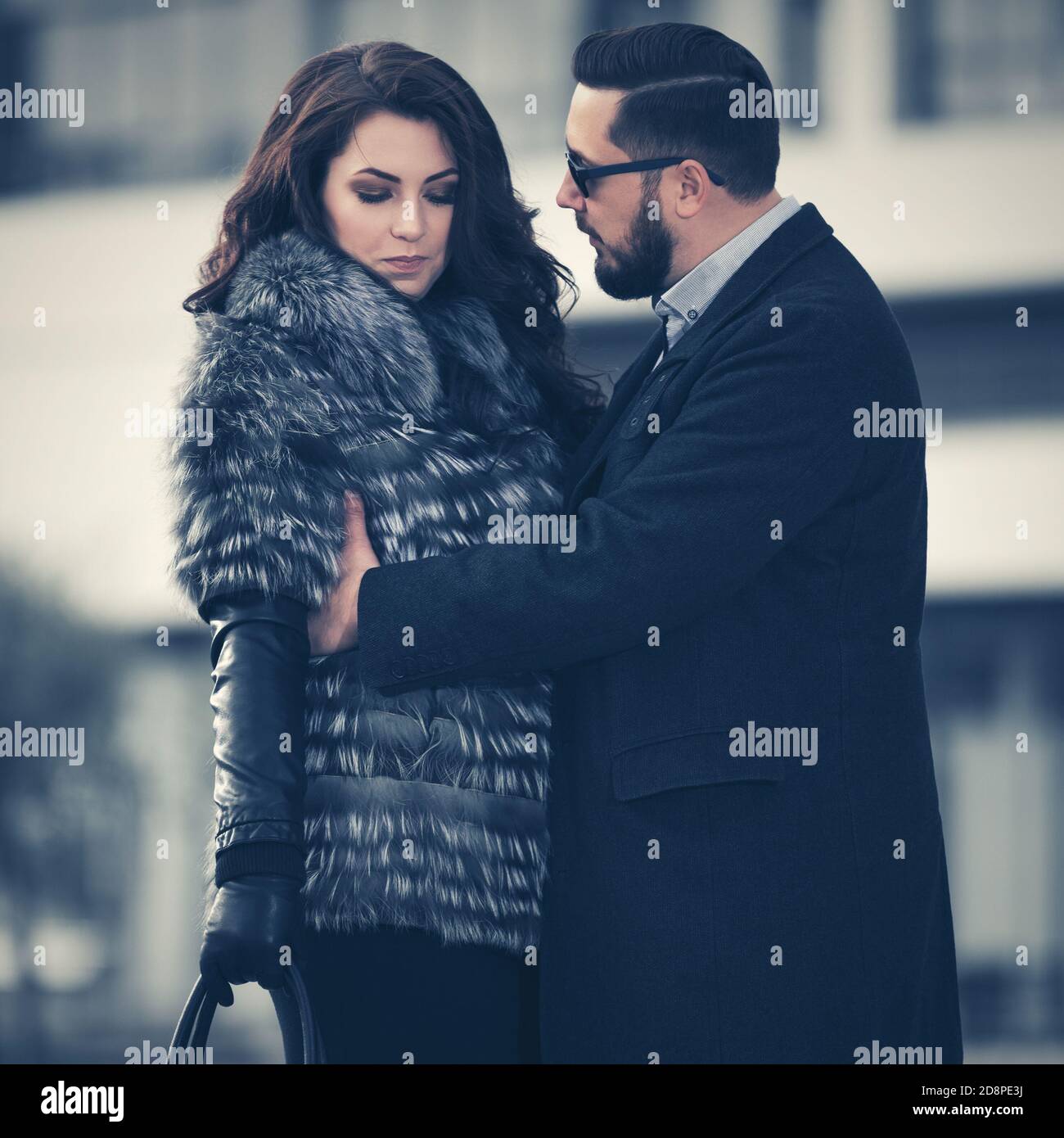 Young fashion couple in conflict in city street Stock Photo