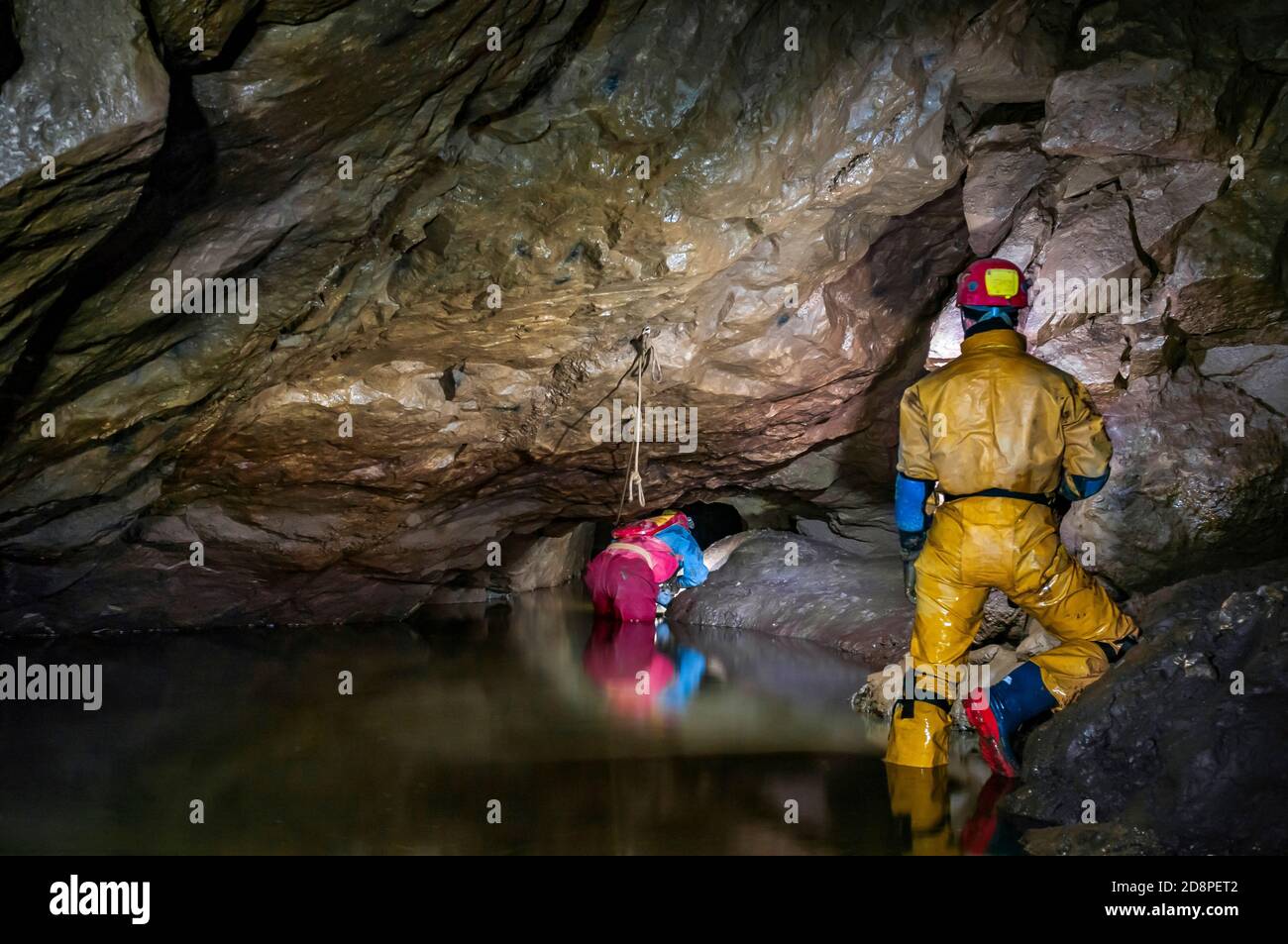 A part-flooded natural cave chamber with a lead miners' tunnel blasted at the far end, in Speedwell Cavern in Castleton, Derbyshire. Stock Photo