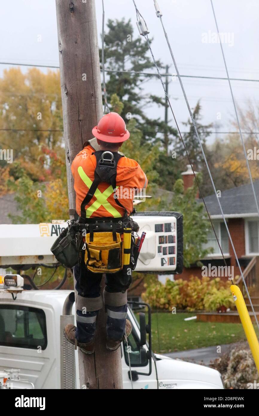 Linesman climbing pole Stock Photo