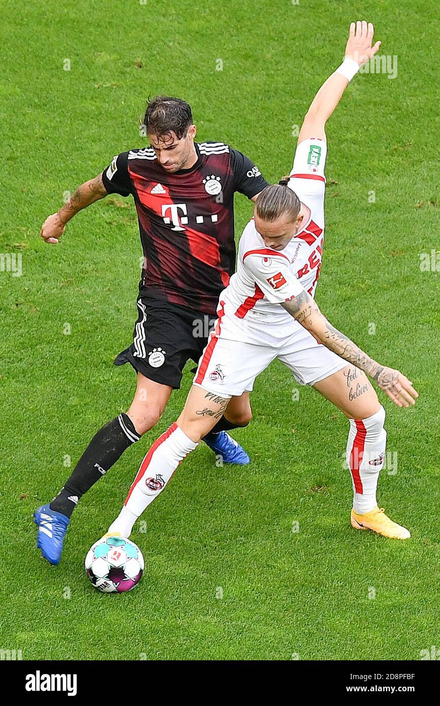 Cologne, Germany. 31st Oct, 2020. Javi Martinez (L) of Munich vies with Marius Wolf of Cologne during a German Bundesliga football match between FC Bayern Munich and FC Cologne in Cologne, Germany, Oct. 31, 2020. Credit: Ulrich Hufnagel/Xinhua/Alamy Live News Stock Photo