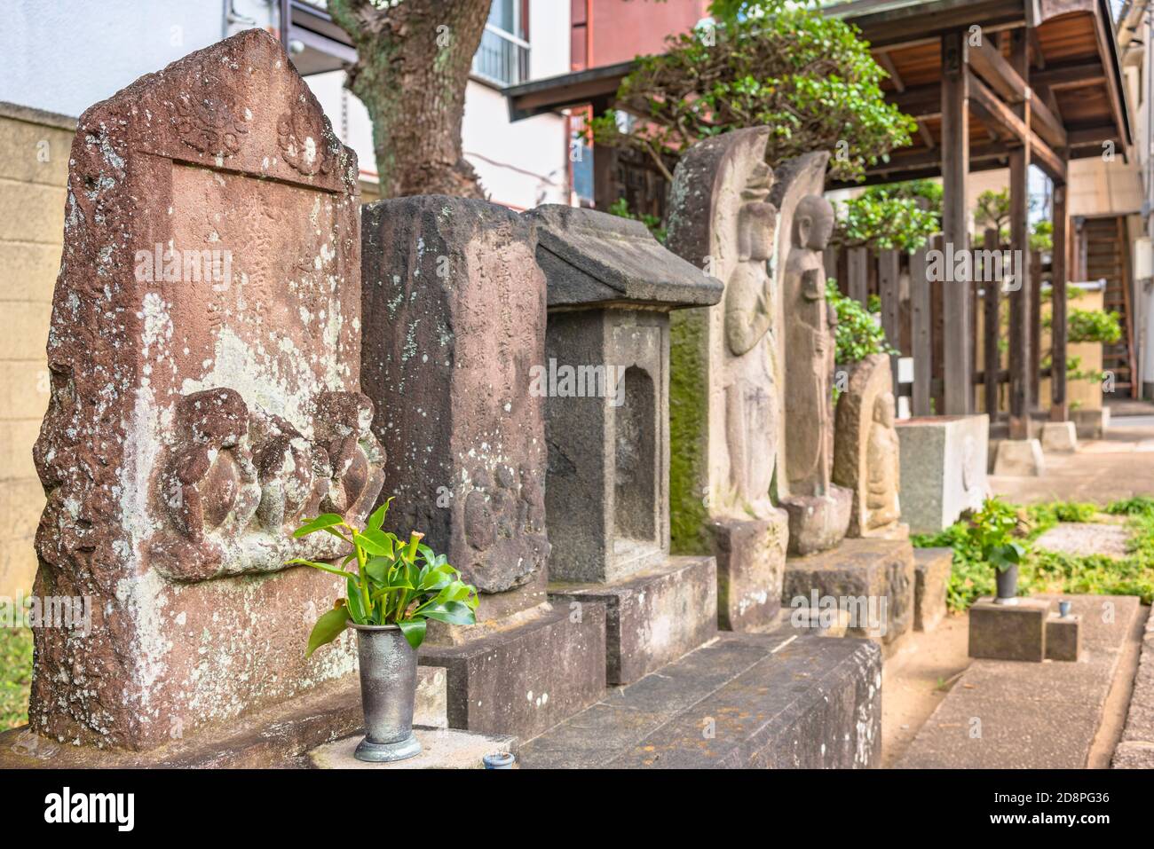 tokyo, japan - october 30 2020: Ancient Kōshintō carved religious stones from Taoist Buddhism depicting the three wise monkeys which are Mizaru, Kikaz Stock Photo