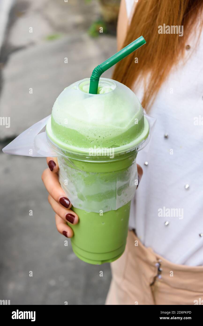 Close-up of woman hold smoothies plastic glass with a straw Stock Photo