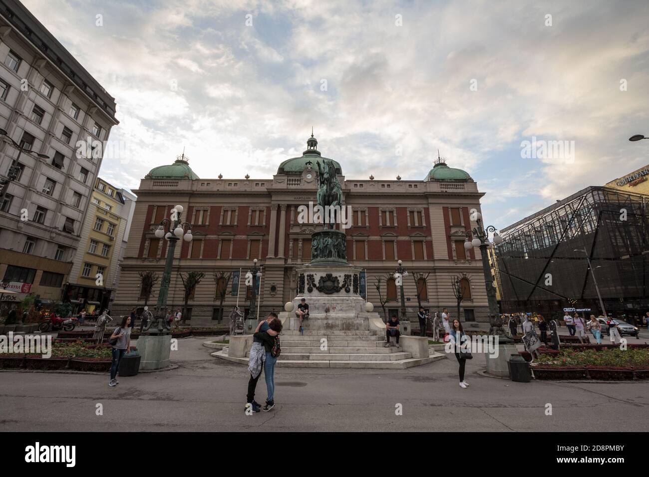 BELGRADE, SERBIA - JULY 19, 2018: Lovers kissing on Trg Republike, or Republic square with Prince Mihailo (Knez Mihailo) statue in front of National M Stock Photo