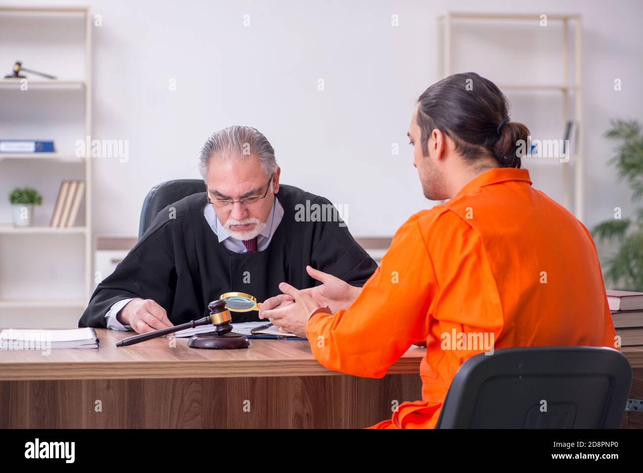 Old judge meeting with young captive in courthouse Stock Photo Alamy