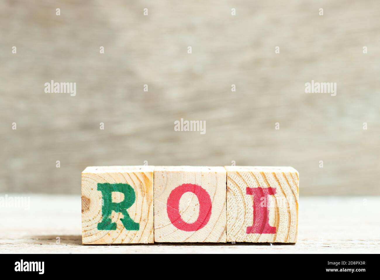 Alphabet letter in word ROI (Abbreviation of Return on Investment) on wood background Stock Photo