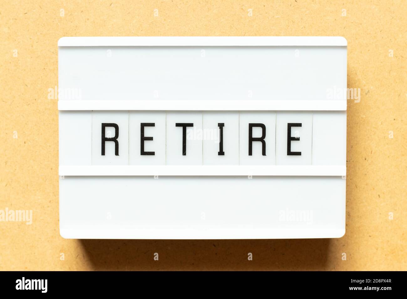 Lightbox with word retire on wood background Stock Photo
