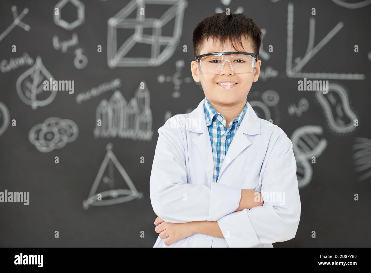 Cheerful schoolboy in labcoat Stock Photo