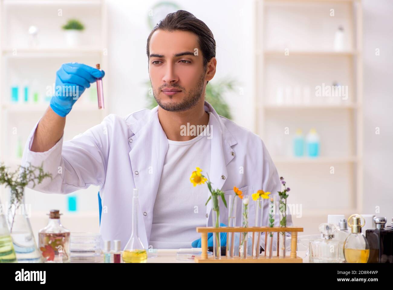 Young chemist in perfume synthesis concept Stock Photo Alamy