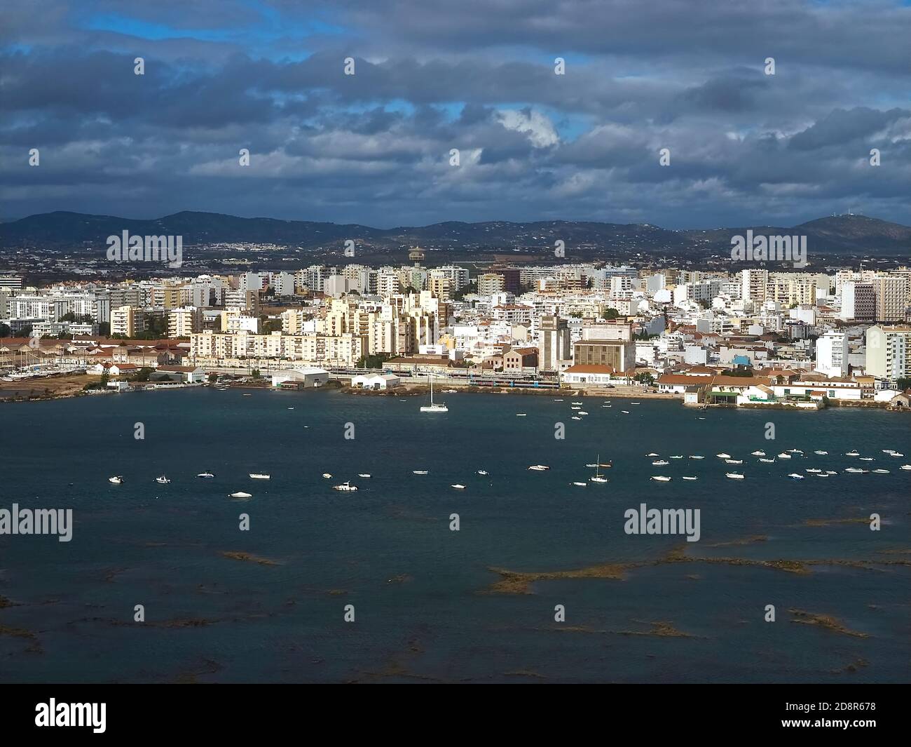 Aerial view of the Cityscape of Faro at the Algarve coast in Portugal seen from an airplane Stock Photo