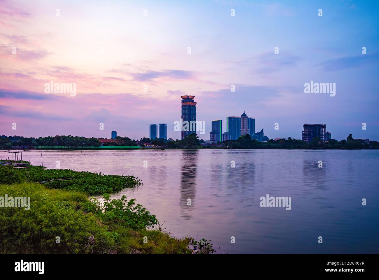 Tangerang, Indonesia - 14th April 2019: A view of Kelapa Dua Lake in the foreground and Lippo Karawaci district buildings in the background. Taken in Stock Photo