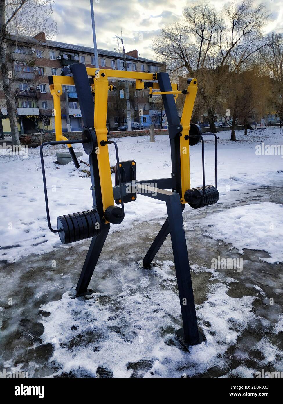 Strength training in an open area of the park in the early winter ...