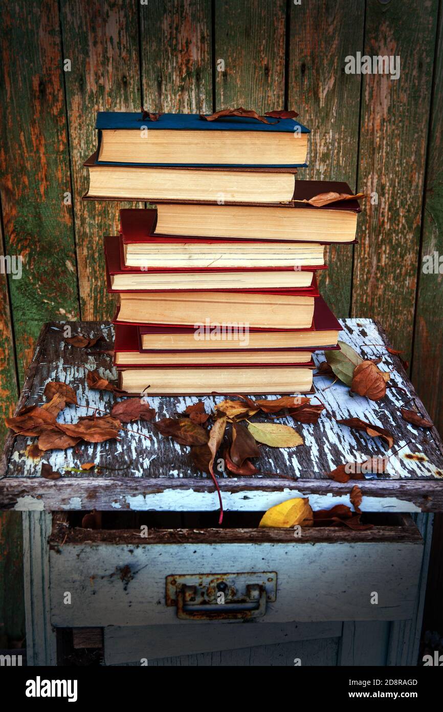 Toned Photo of Pile of Books on the Old Table outdoor Stock Photo - Alamy