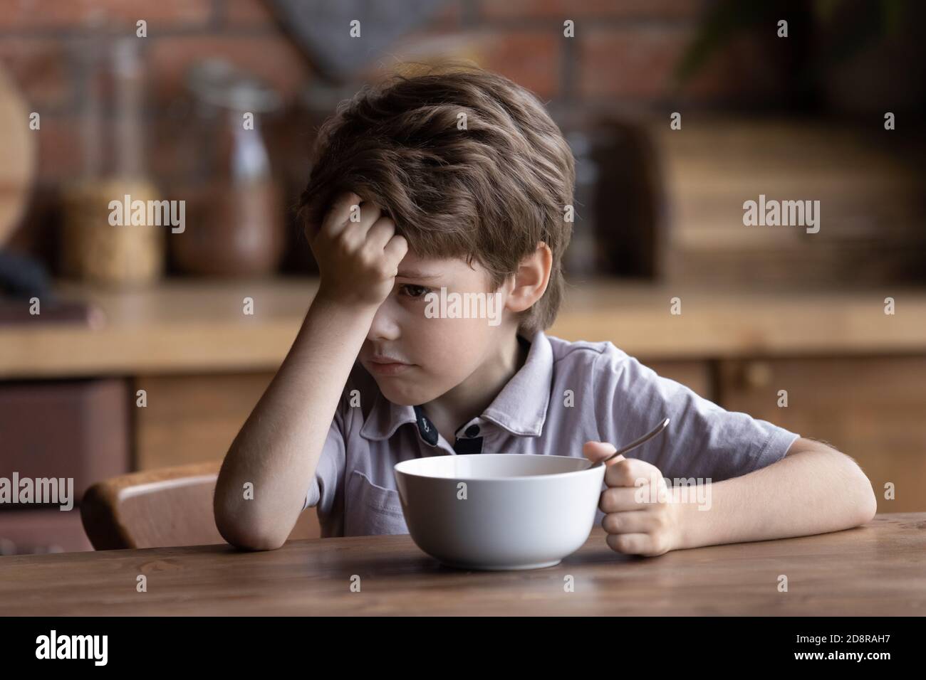 Unhappy little boy child refuse eating healthy food Stock Photo
