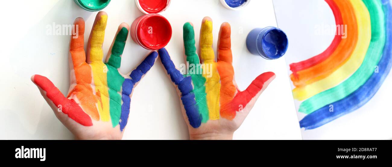 Rainbow painted hand shape isolated on white. Hand painted rainbow, painted rainbow and open paints Stock Photo