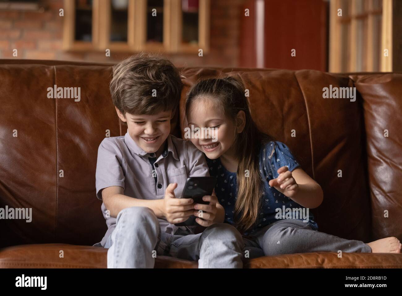 Happy little children have fun using smartphone Stock Photo - Alamy