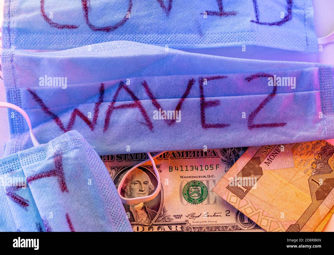 Impact of Second Wave of Coronavirus on the World Economy concept. One Dollar bill under a surgical mask with red and blue emergency lights Stock Photo