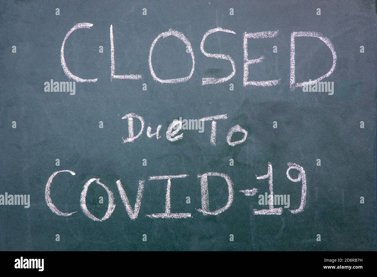 Closed Due To Coronavirus text infront of a cafe shop. Impact of coronavirus on business. Stock Photo