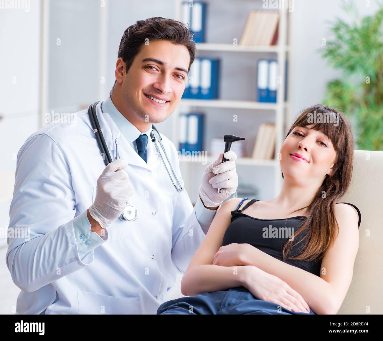 The doctor checking patients ear during medical examination Stock Photo