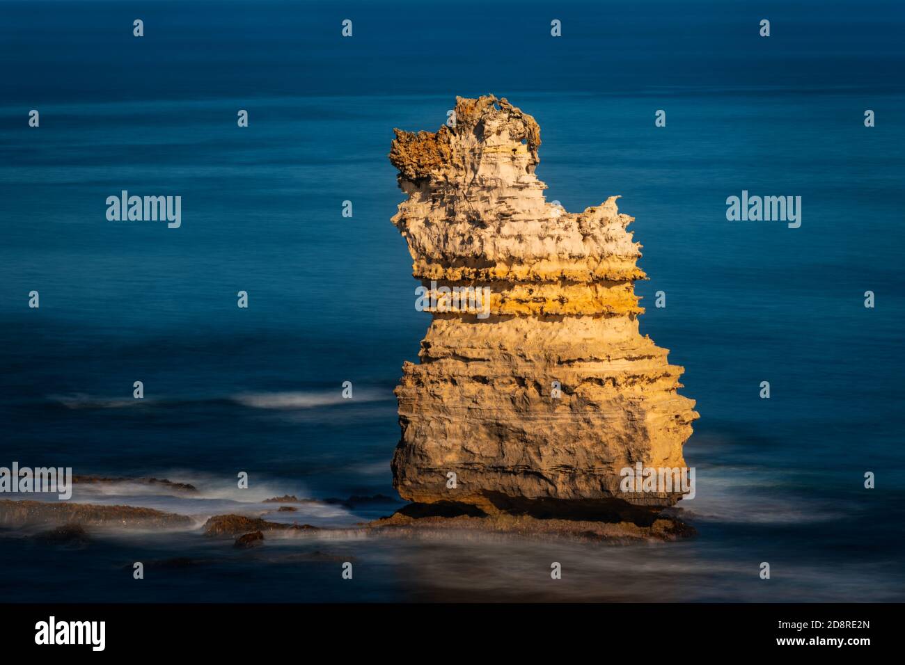 Lonely sea stack in Bay of Islands Coastal Park at the famous Great Ocean Road. Stock Photo