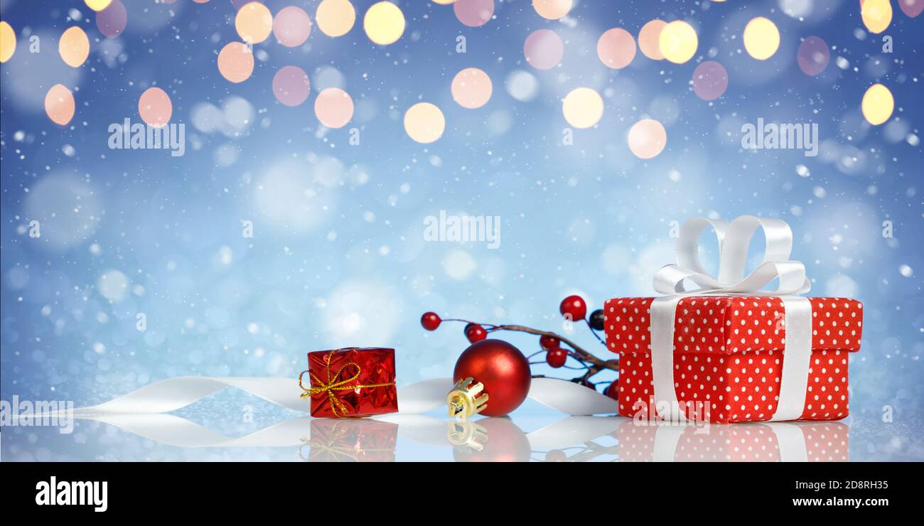 Decorative red gift box with a white bow with chtistmas decorations Stock Photo