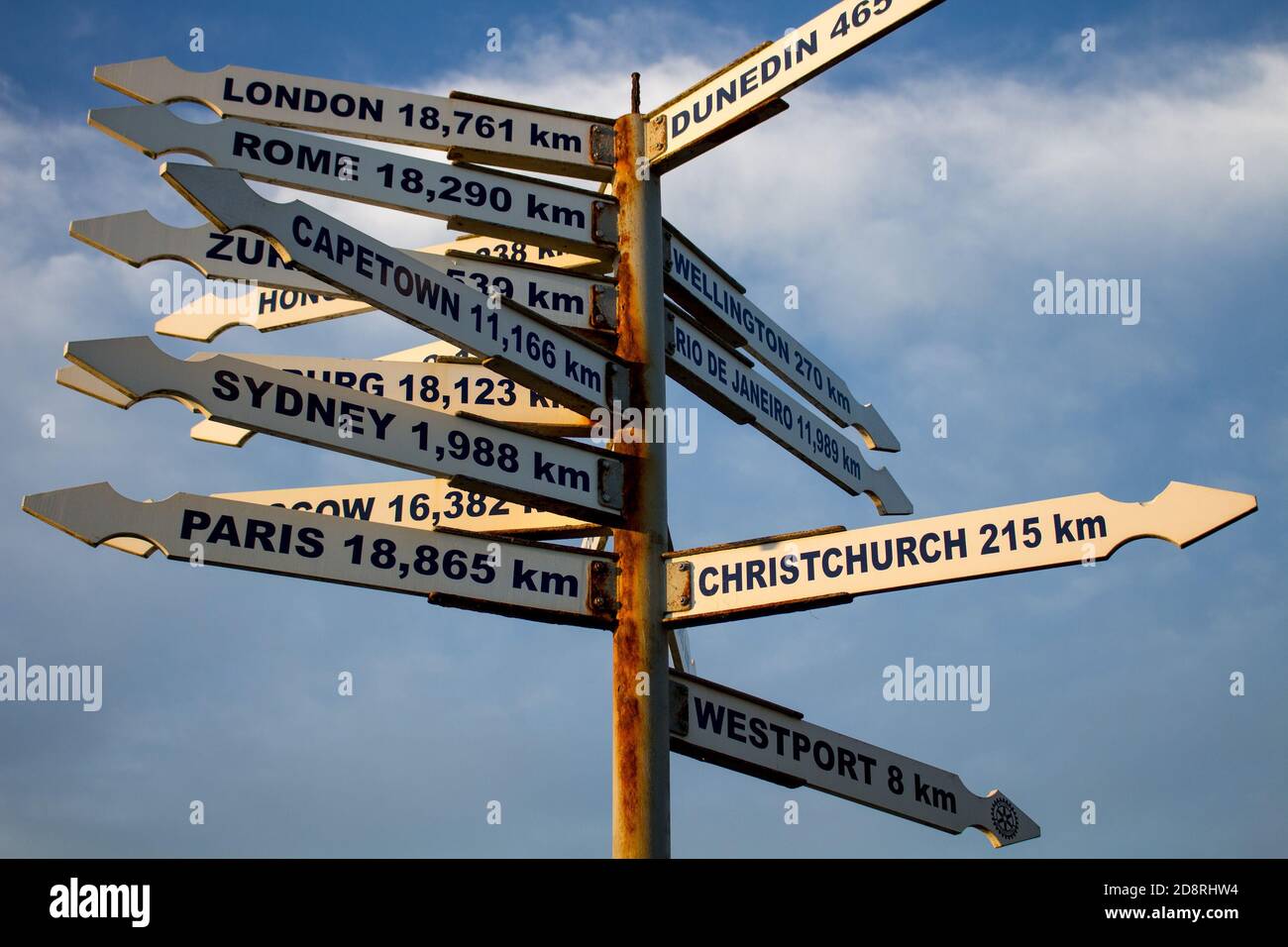 Post showing distance and direction to many cities around the world located in Tauranga bay seal colony New Zealand South island Stock Photo