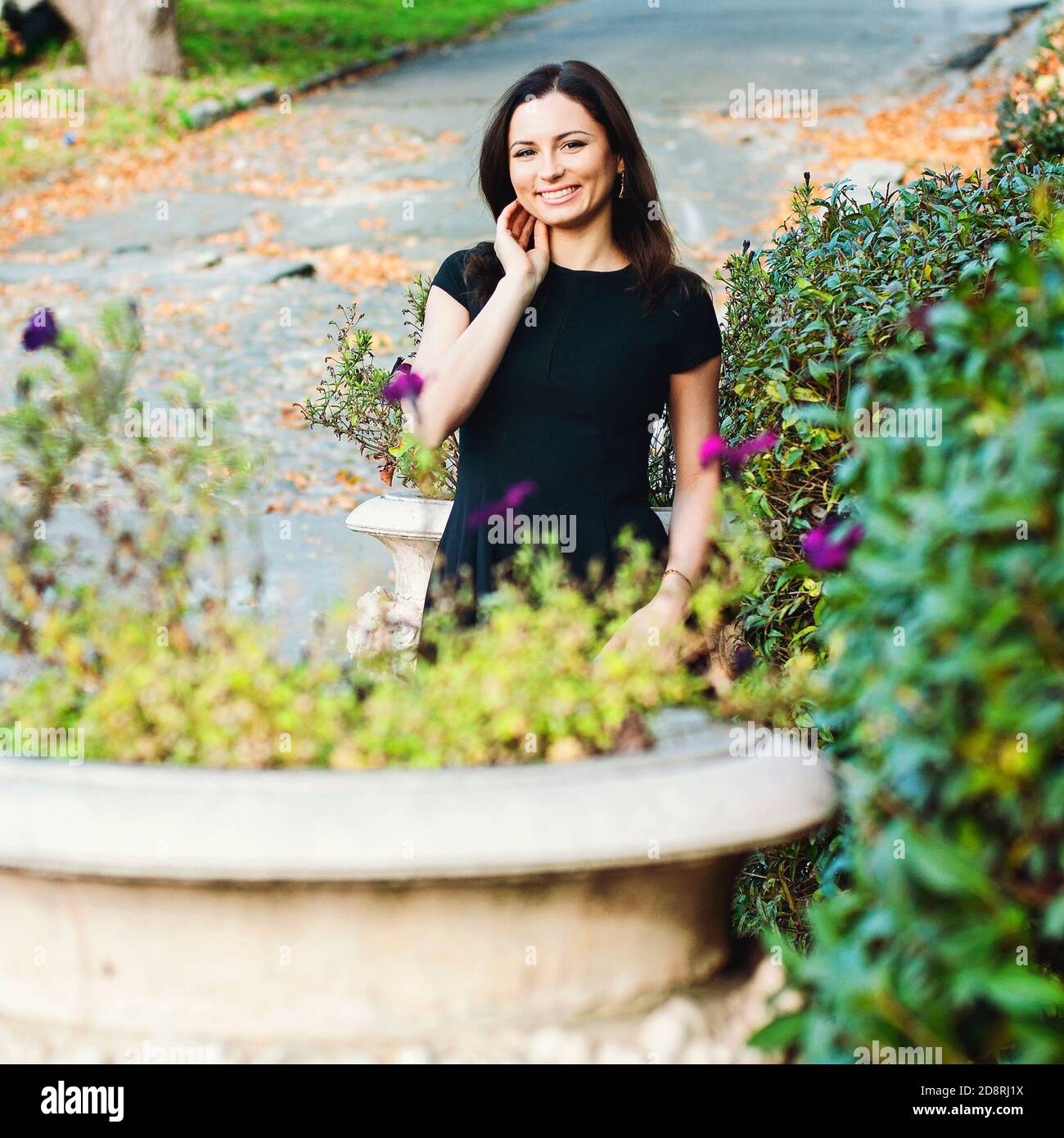 Beautiful woman in black dress walking hi-res stock photography and ...