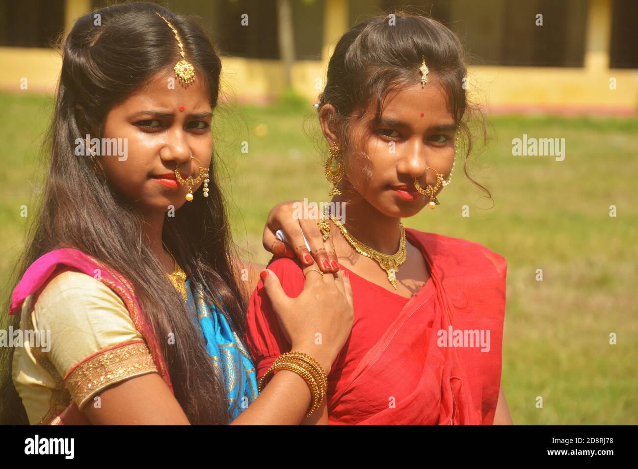 Close up of two sisters wearing traditional saree and jewelleries like nose rings earrings maang tika bangles during  Durga Puja, selective focusing Stock Photo