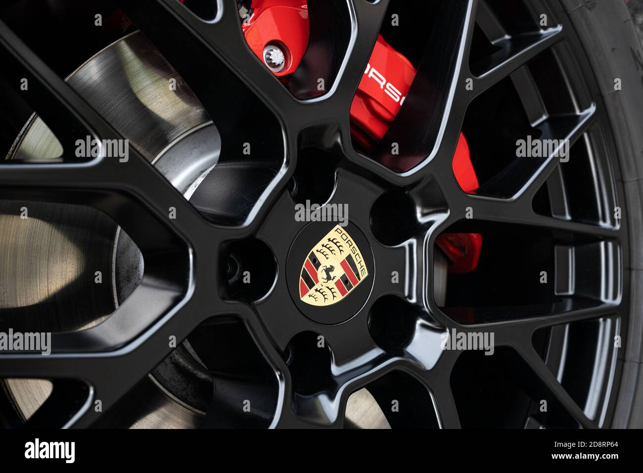 Galicia, Spain. October 30 2020: Black Wheel rim and red brake caliper of a Porsche car Stock Photo