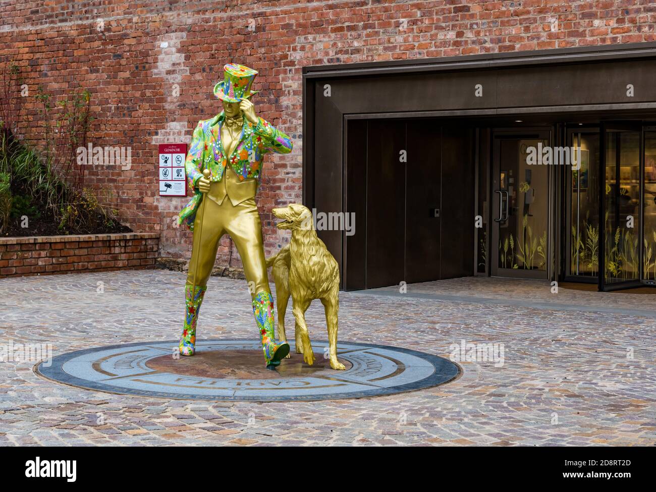 Johnnie Walker striding man statue with dog outside Glenkinchie Distillery, East Lothian, Scotland, UK Stock Photo
