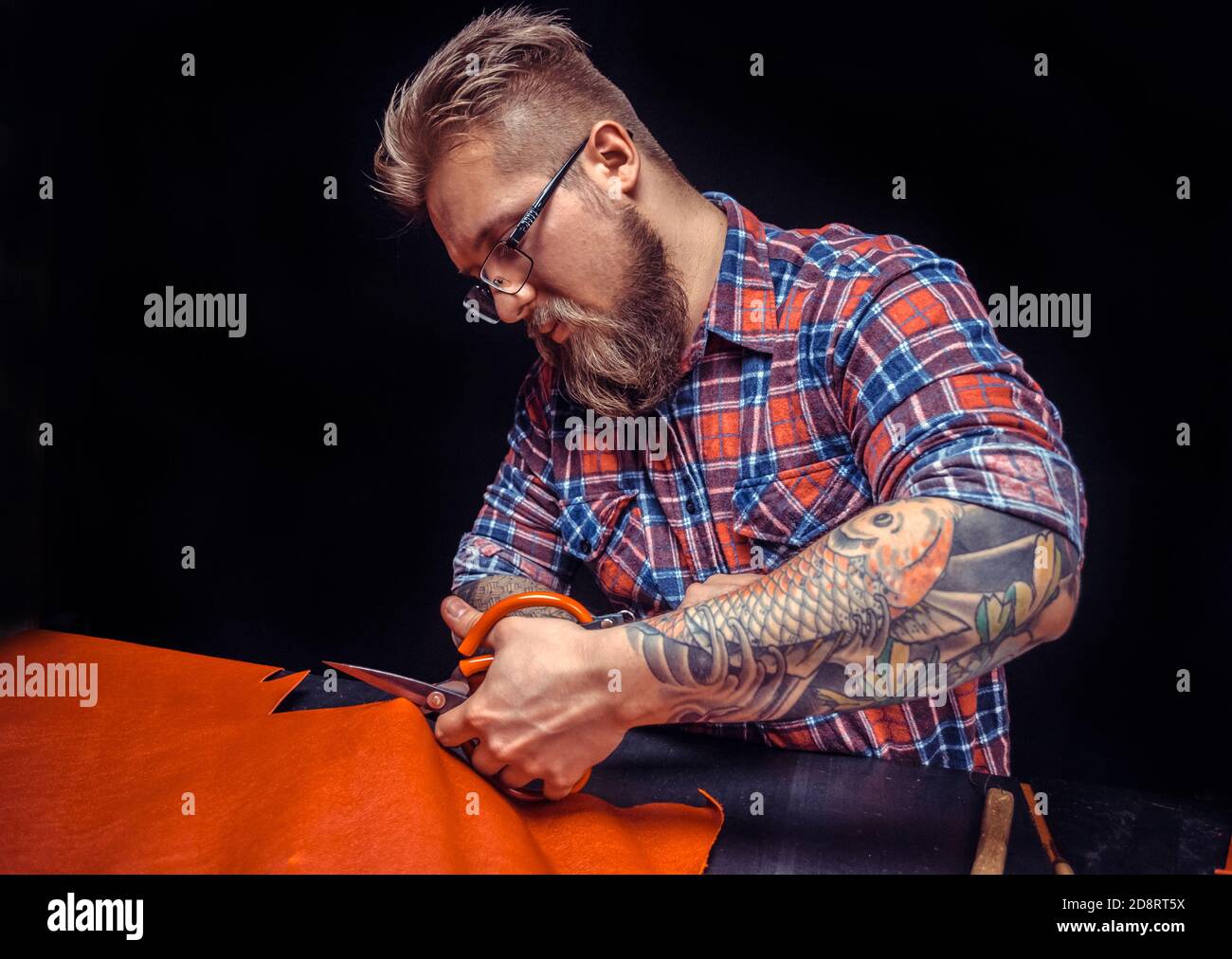 Currier wording with leather goods at the leather studio Stock Photo