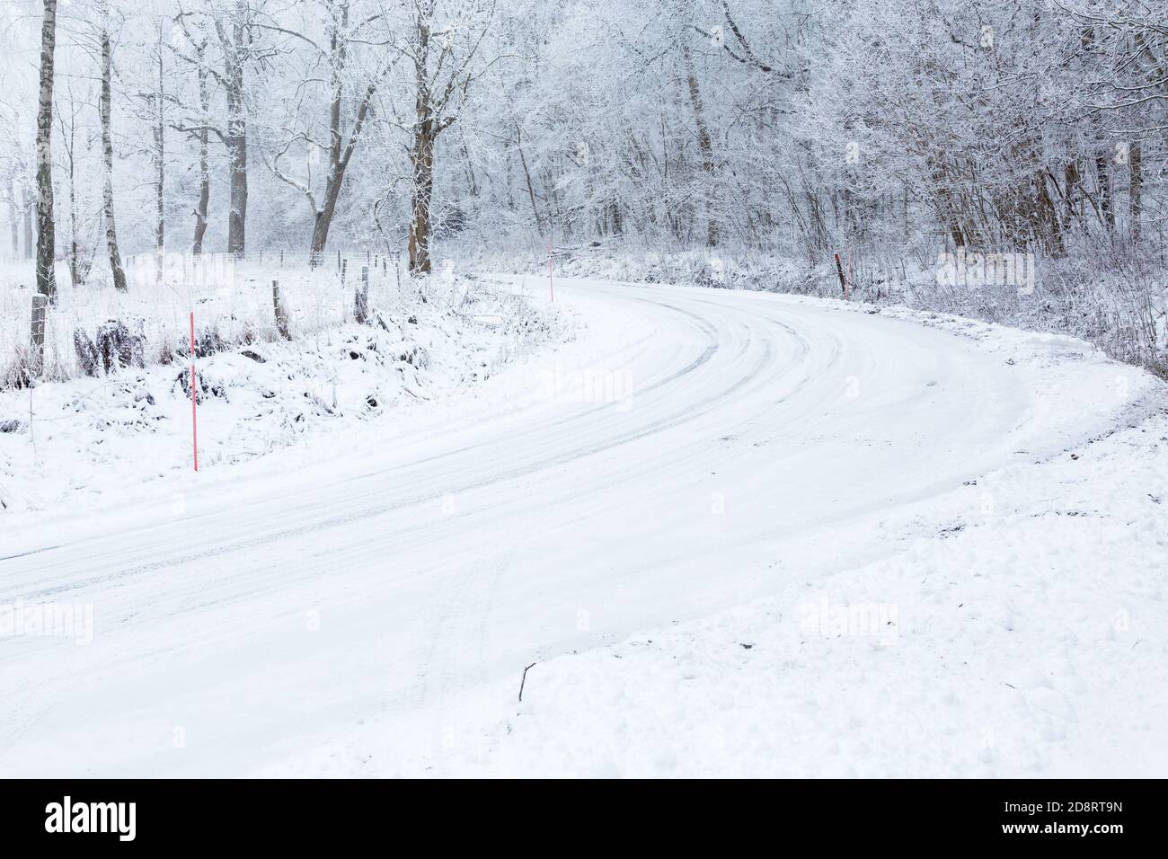 Road curve with slippery conditions in winter Stock Photo - Alamy