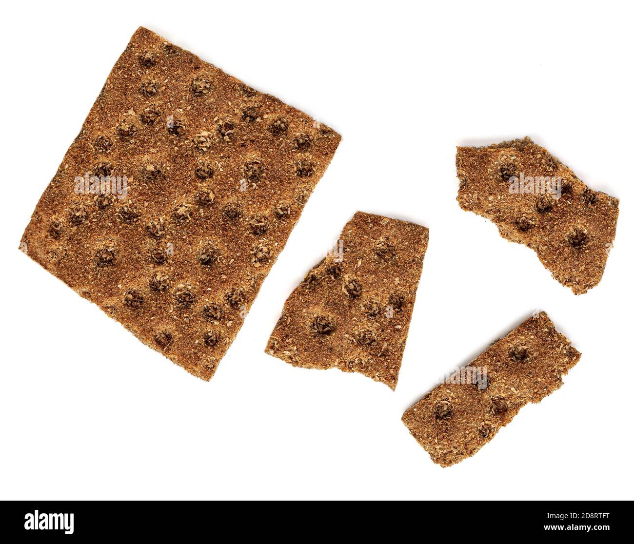 Rye crispy crackers  isolated on white background. Crushed dry wholegrain cracker pieces or flat bread. Top view Stock Photo