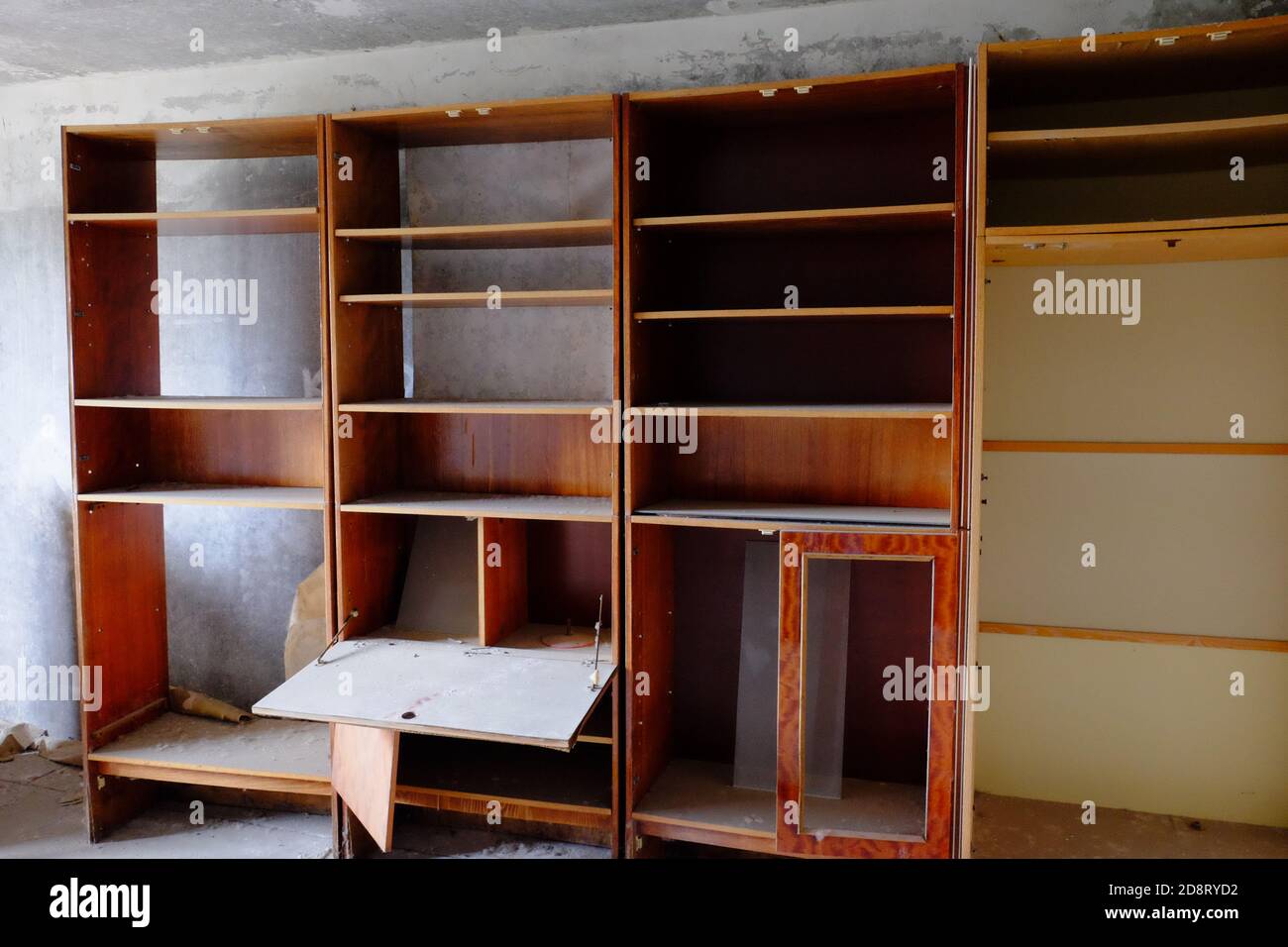 Broken wooden cabinets in an abandoned room. Old Soviet furniture