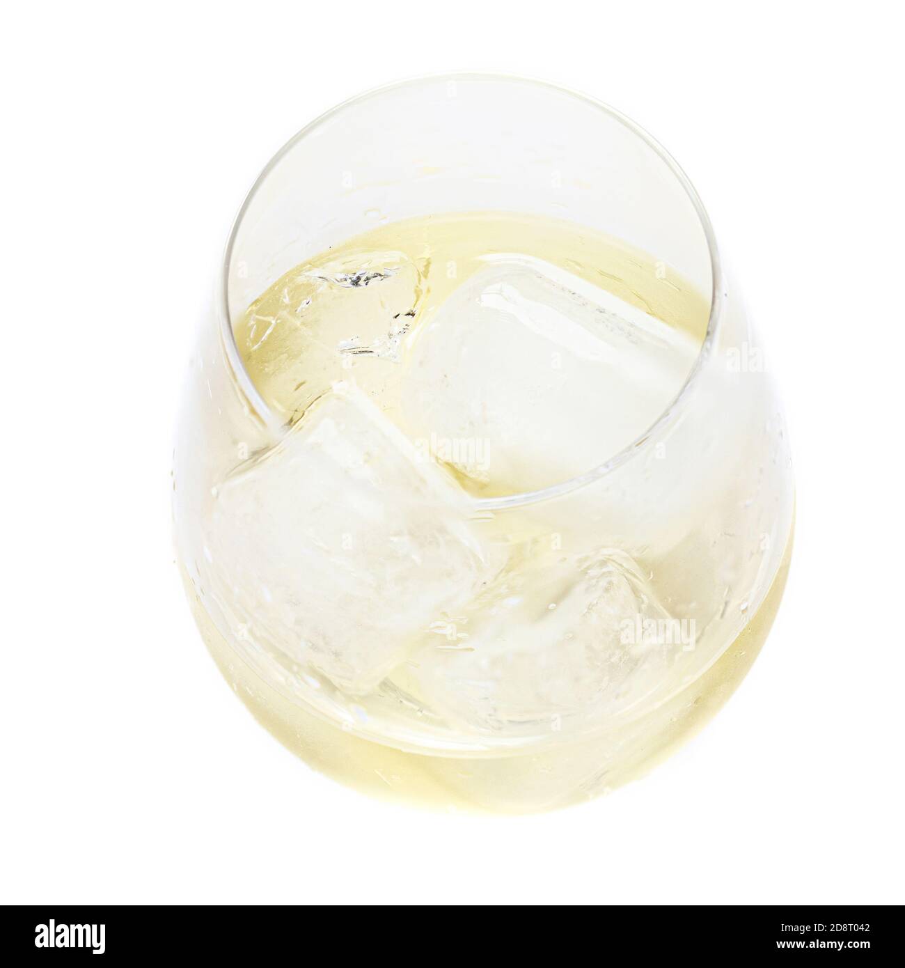 Glass of white wine with ice cubes isolated on white background, top view. Summer drinks concept