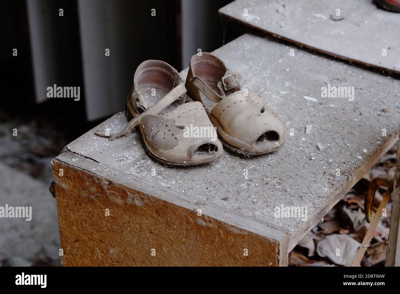 Small children's sandals in an abandoned kindergarten in Pripyat. Old children's shoes. Stock Photo