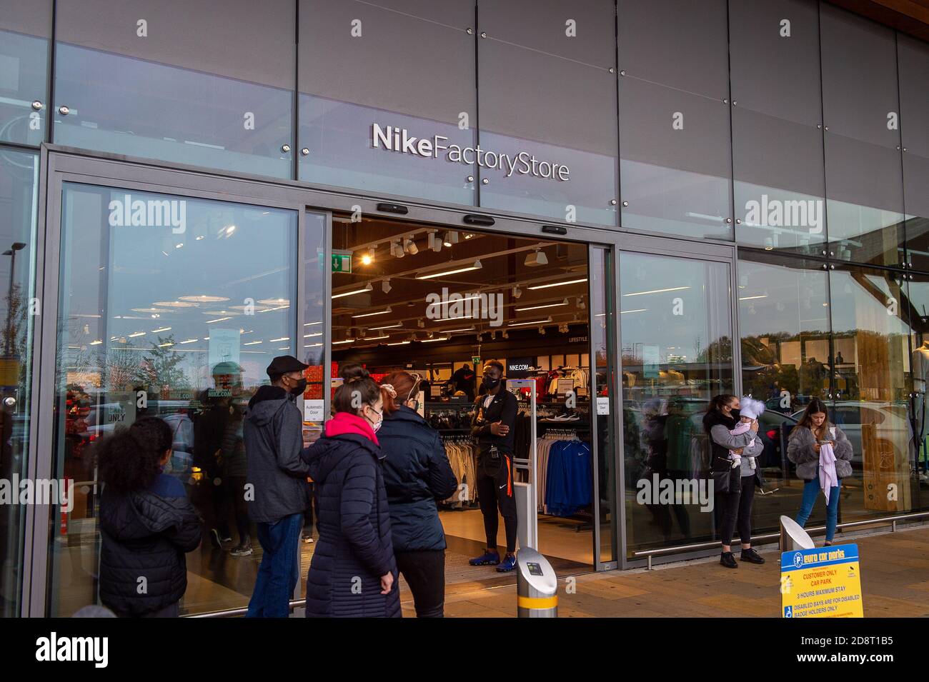 Taplow, Buckinghamshire, UK. 1st November, 2020. Shoppers queue to enter the Nike Factory Shop. The car park at the Bishop Centre Retail Park in Taplow, Buckinghamshire this morning was full. Shoppers were out in force doing pre lockdown shopping as well as buying Christmas presents. Boris Johnson announced last night that England is going into a second lockdown from later this week following the big increase in positive Covid-19 cases. Essential shops will, however, remain open. Credit: Maureen McLean/Alamy Live News Stock Photo