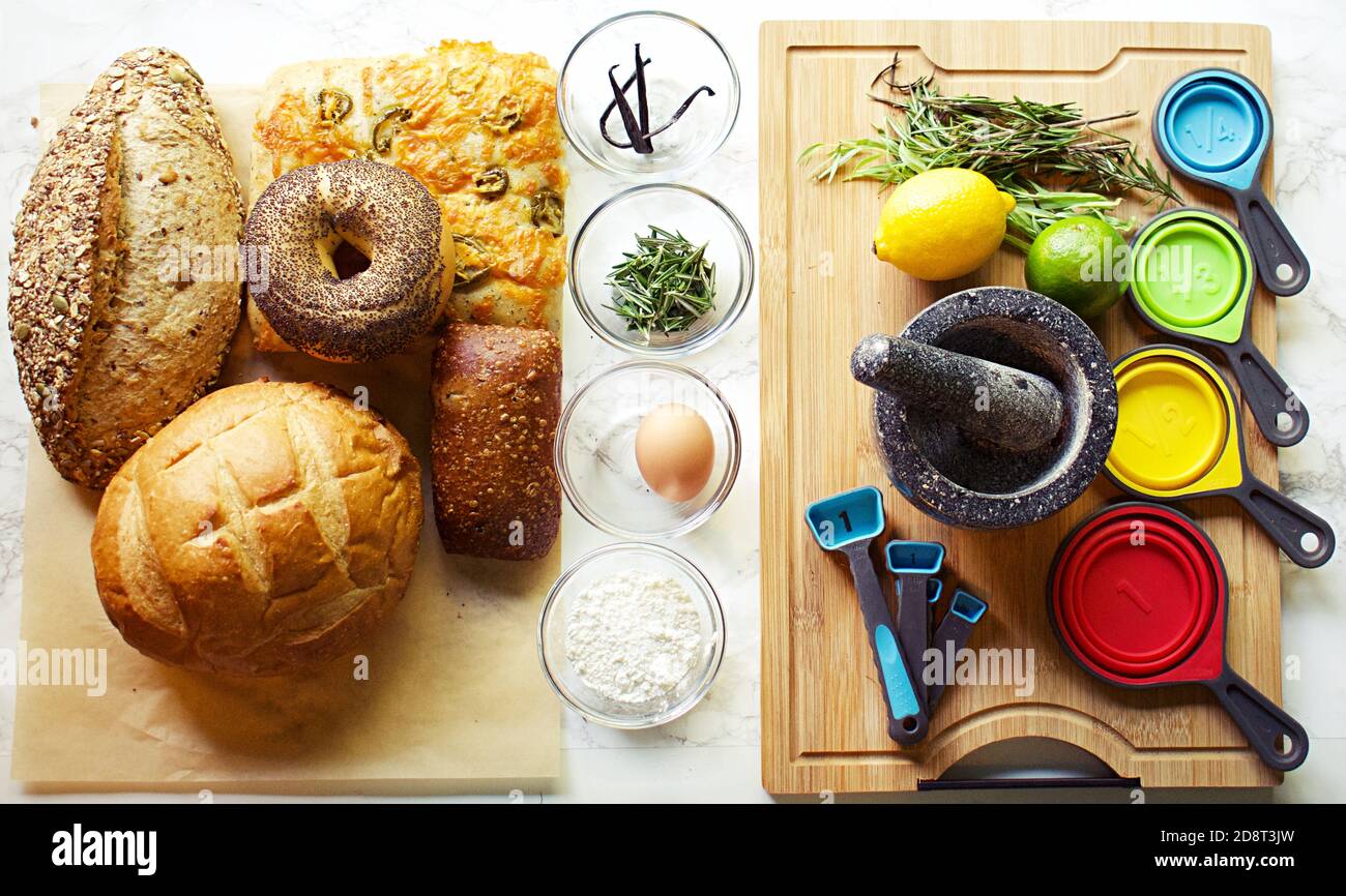 Group of baked goods on baking paper with ingredients in small glass ...