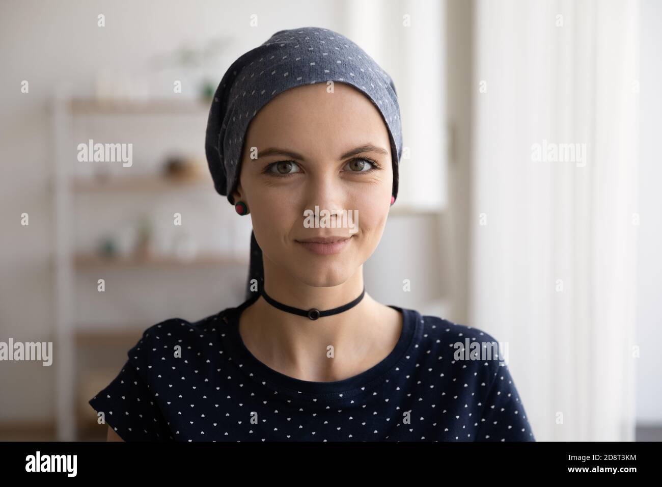 Head shot portrait attractive hairless woman wearing head scarf Stock Photo