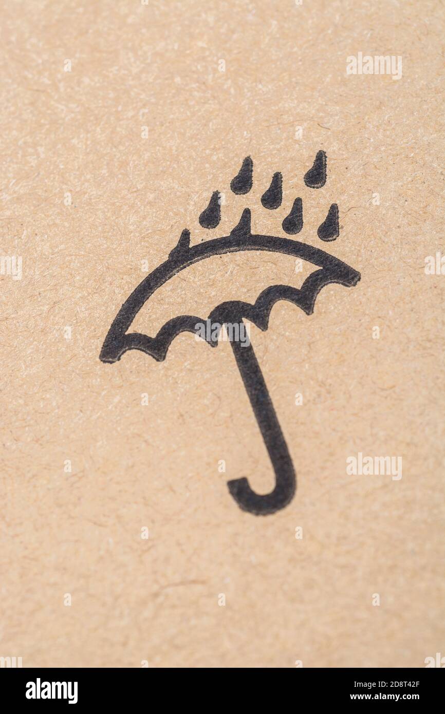 International packaging icon of an umbrella with raindrops, meaning to keep the contained products dry / out of the rain / away from water. Stock Photo