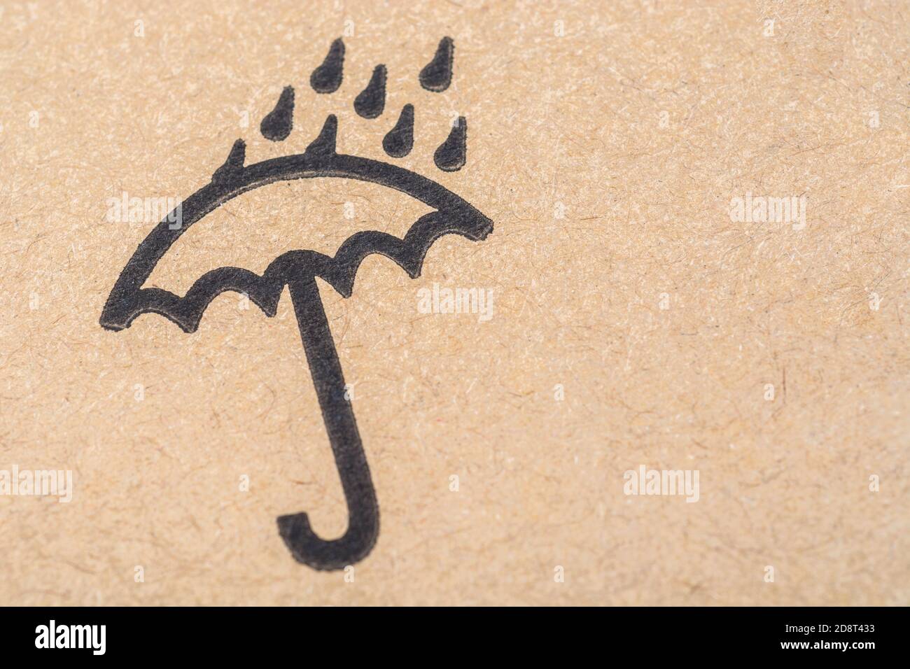 International packaging icon of umbrella with raindrops, meaning keep the contained products dry / out of the rain / away from water. Copy space RHS. Stock Photo