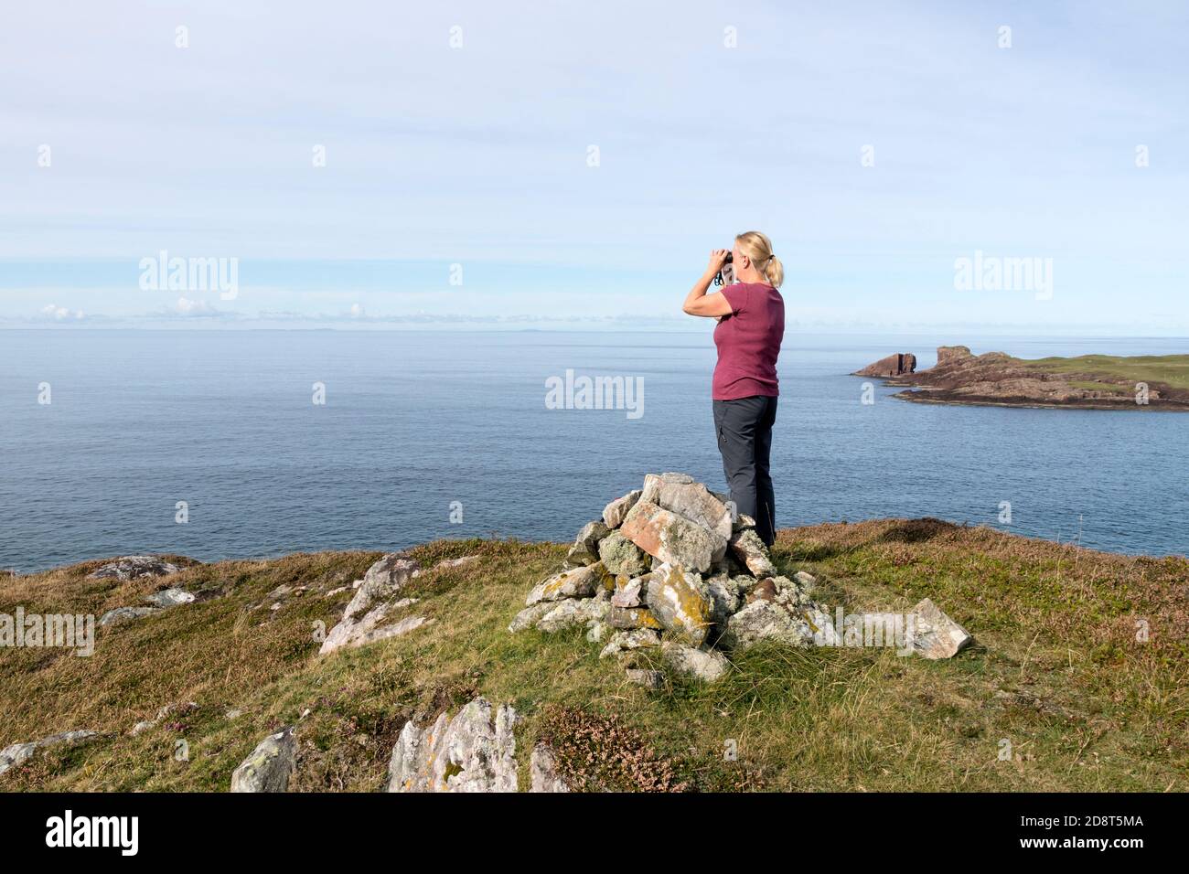 Woman Wildlife Watching near Split Rock, Clachtoll, Assynt, NW Highlands, Scotland, UK Stock Photo
