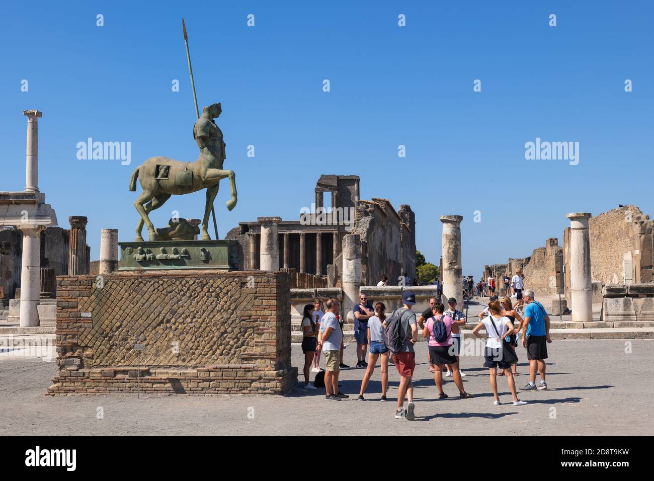 Pompeii Forum with statue of Centaur, Campania, Italy, group of people, tourists on a sightseeing tour Stock Photo