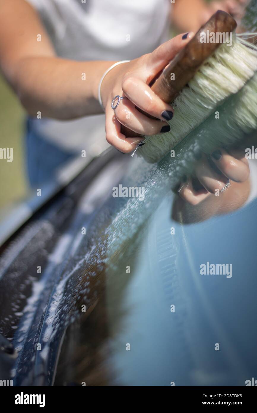 Close up of a women washing a car Stock Photo