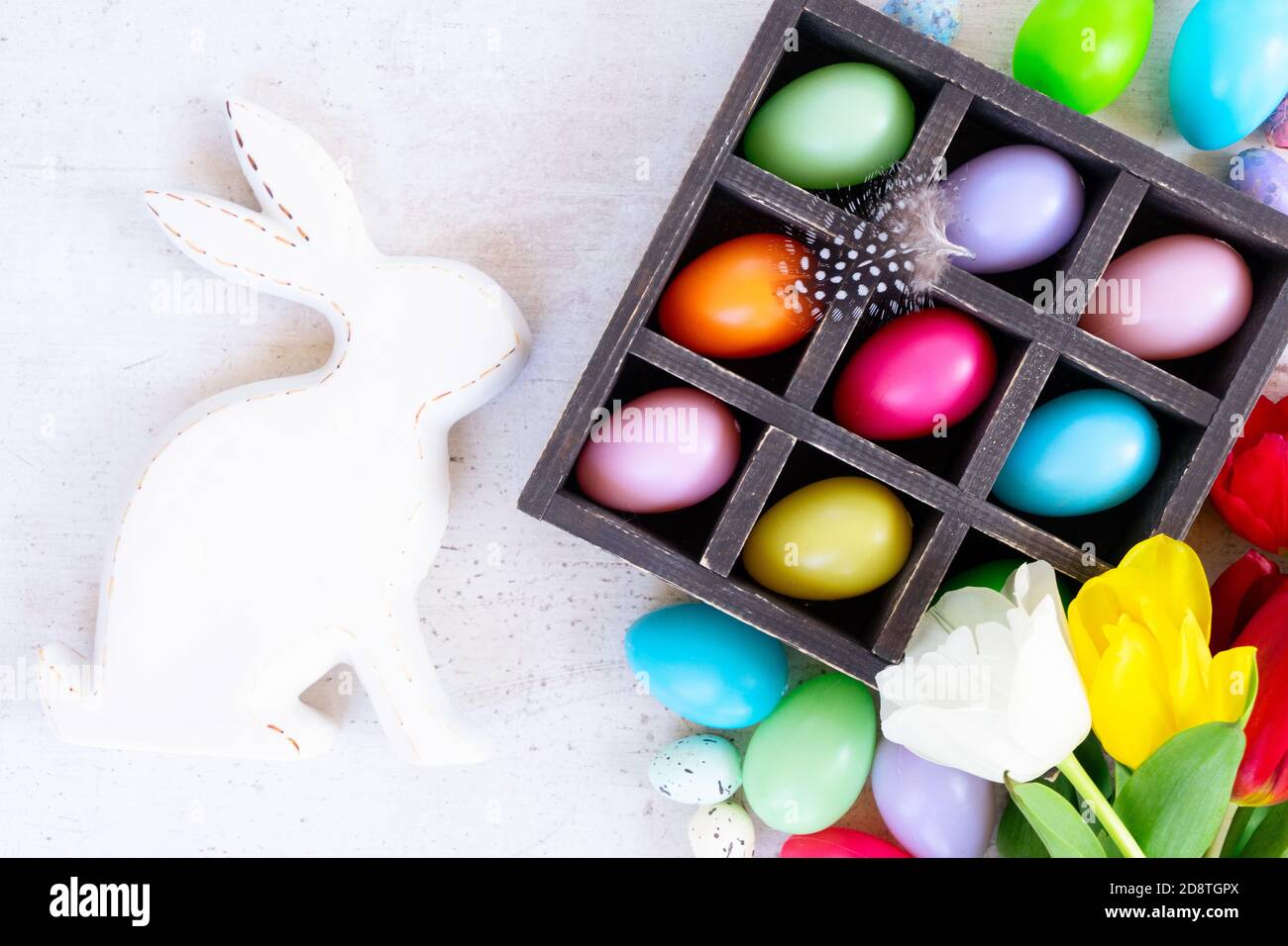 Easter colored eggs with tulips Stock Photo - Alamy