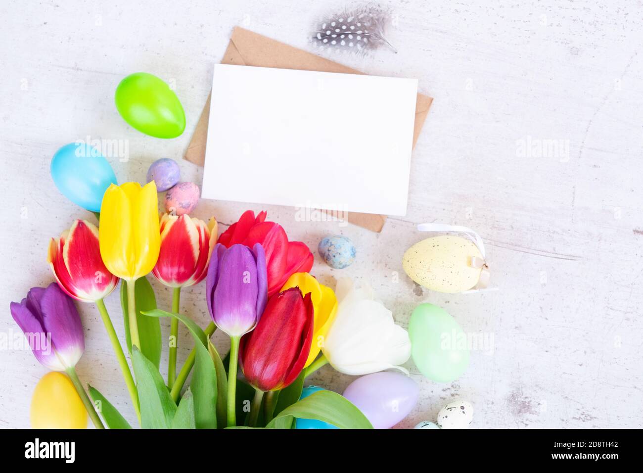 Easter colored eggs with tulips Stock Photo - Alamy