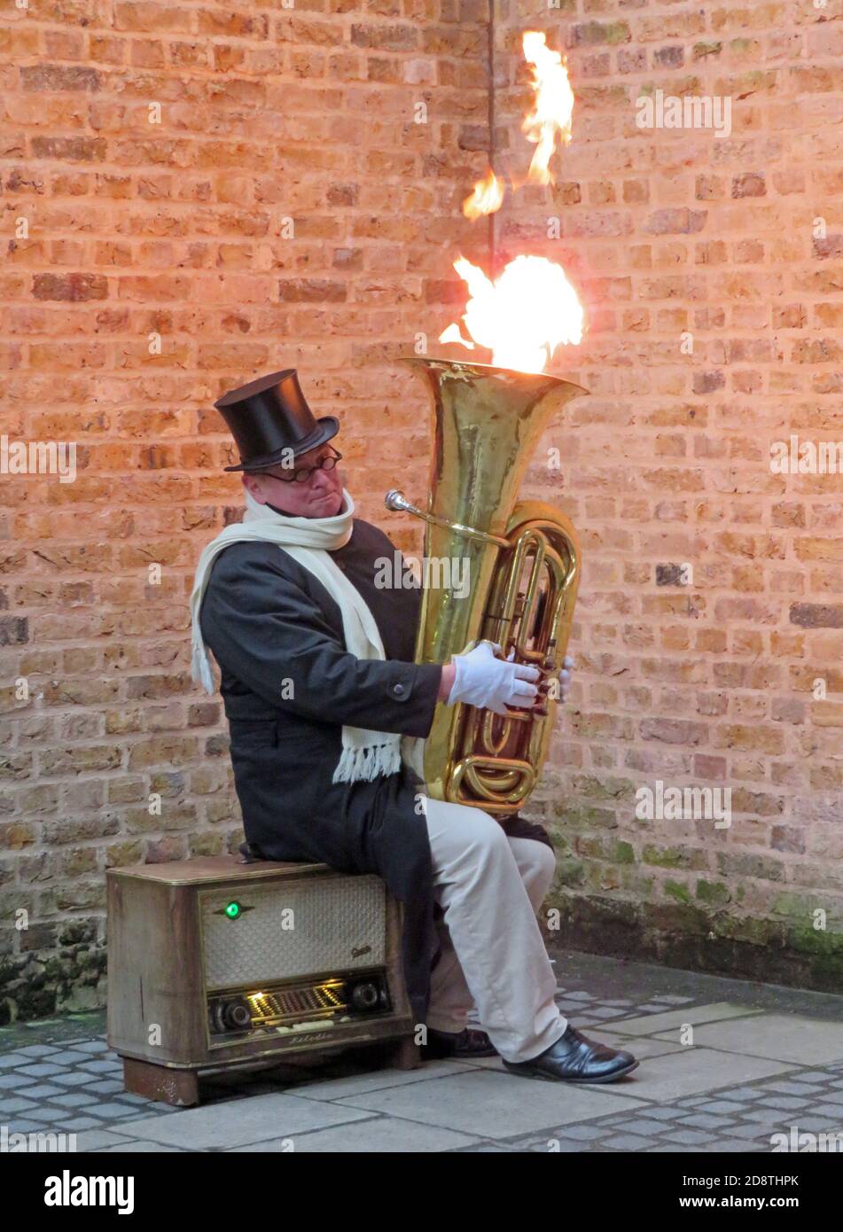 LONDON, UNITED KINGDOM - Feb 15, 2018: A street performer in London on the banks of the Thames. Flames regularly came out of the bell of the tuba Stock Photo